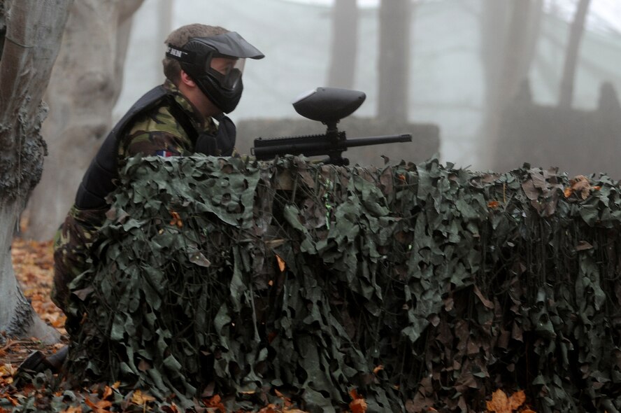RAF MARHAM, England -- An airman from RAF Marham plays paintball during Leader, Ethos and Air Power Training Day here Dec. 6, 2010. This activity demanded the team members work together to capture the flag of the opposing team through planning, communication and physical stamina. (U.S. Air Force photo/Senior Airman Tabitha M. Lee)
