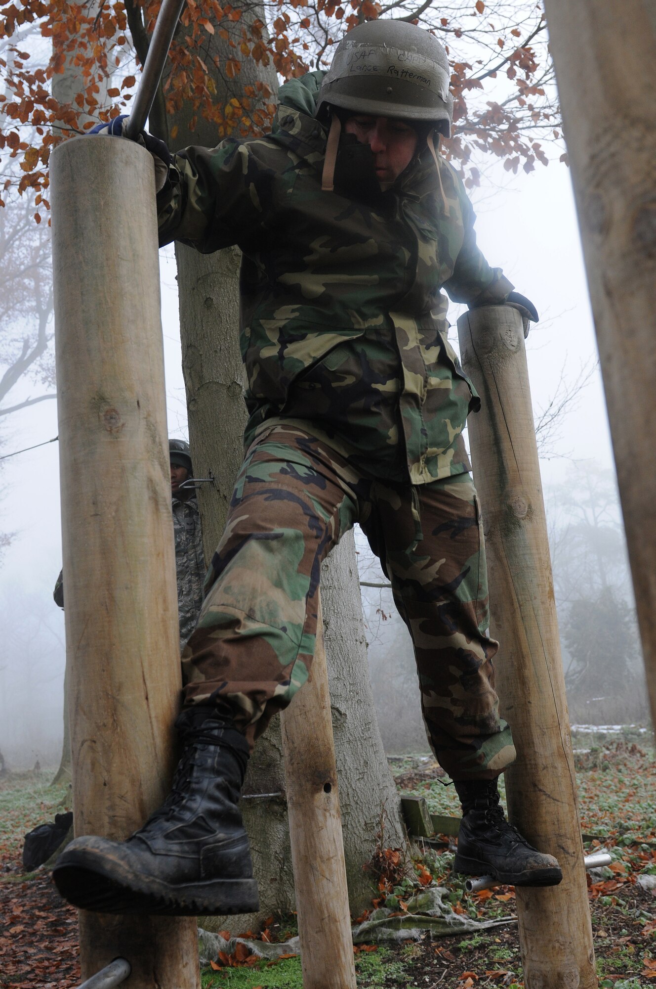 RAF MARHAM, England -- Tech. Sgt. Travis Romesha, 100th Air Refueling Wing Inspections and Readiness, crosses an obstacle at the low-ropes course during Leader, Ethos and Air Power Training Day here Dec. 6, 2010. Activities of the day included paintball, target practice, low-ropes challenge and a mind-over-matter exercise. (U.S. Air Force photo/Senior Airman Tabitha M. Lee)