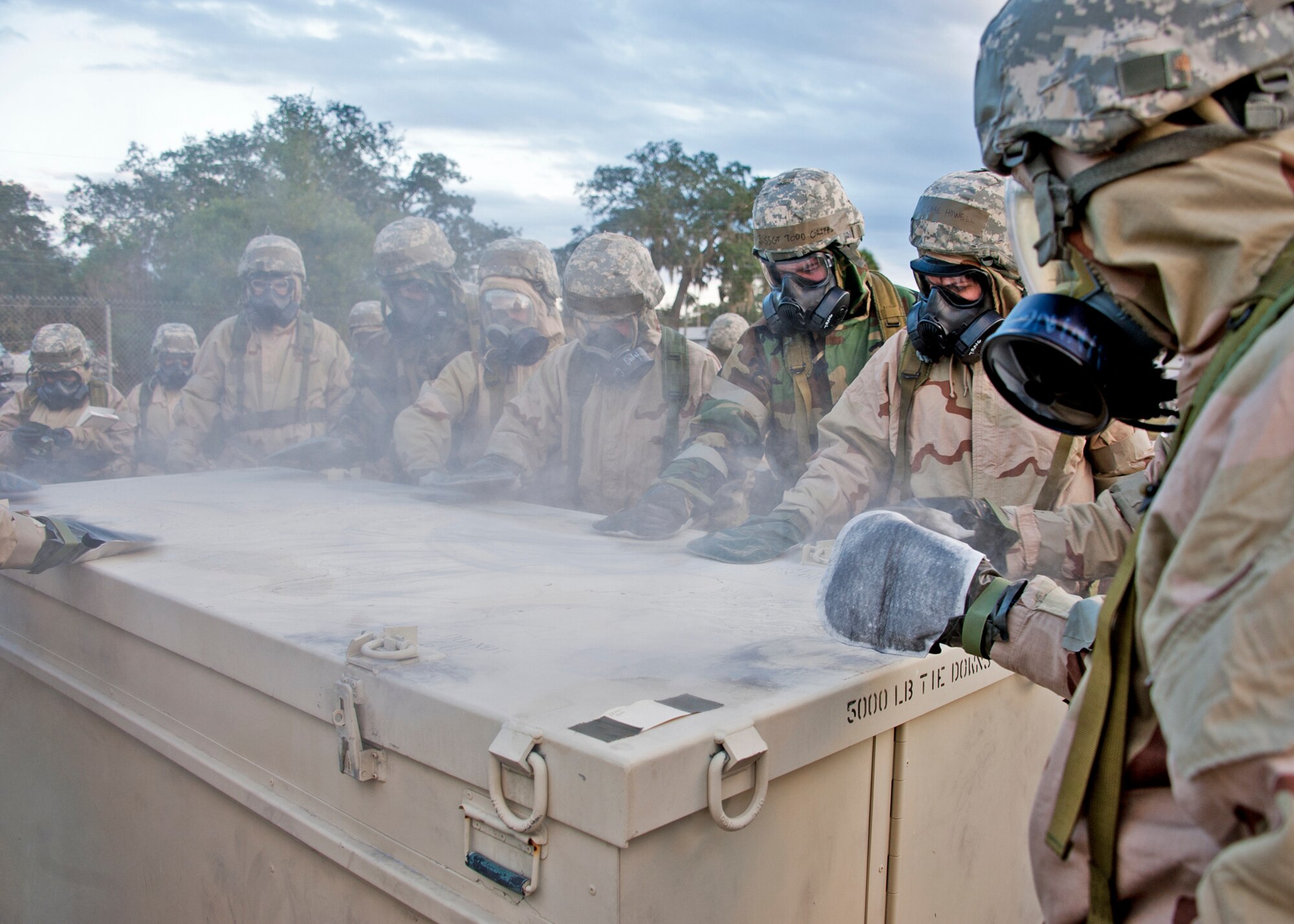 Airmen decontaminate an asset that was contaminated during the simulated attack using their M-295 kits during the chemical, biological, radiological, nuclear and explosive training course at Eglin Air Force Base, Fla.  The eight-hour course combines computer based and hands-on training on how and when to wear the gear, unxploded ordnances and protective measures.  The 96th Civil Engineer Squadron’s emergency readiness flight teaches the hands-on course up to 75 times a year.  (U.S. Air Force photo/ Samuel King Jr.)