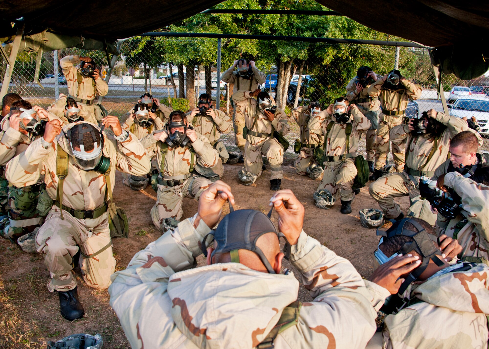 Alarm Black is given, and Airmen must dress out in the full chemical suit, beginning with the gas mask.  This scenario is part of the chemical, biological, radiological, nuclear and explosive training course at Eglin Air Force Base, Fla.  The eight-hour course combines computer based and hands-on training on how and when to wear the gear, unxploded ordnances and protective measures.  The 96th Civil Engineer Squadron’s emergency readiness flight teaches the hands-on course up to 75 times a year.  (U.S. Air Force photo/ Samuel King Jr.)