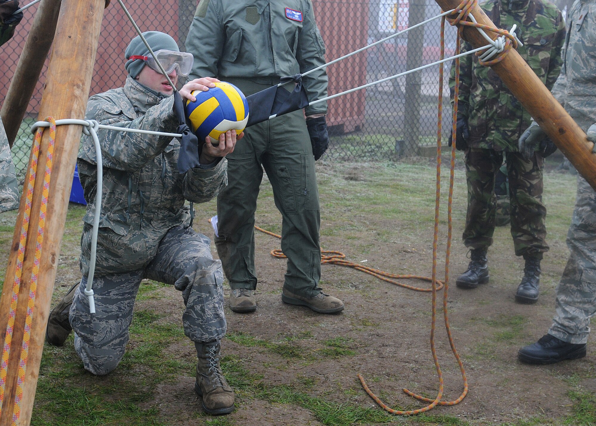 RAF MARHAM, England -- Staff Sgt. Jazz Sutto, 100th Maintenance Squadron, prepares to launch a ball at a target using a sling shot built by his team during Leader, Ethos and Air Power Training Day here Dec. 6, 2010. Teams were given raw materials to build a device to launch a volleyball with distance and accuracy. (U.S. Air Force photo/Senior Airman Tabitha M. Lee)  