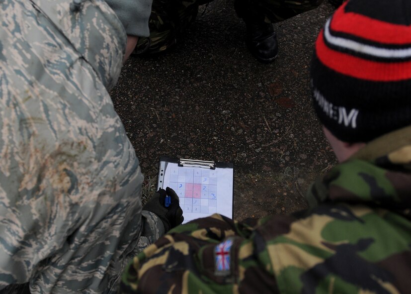 RAF MARHAM, England -- Airmen from RAFs Mildenhall and Marham work together to solve a Sudoku puzzle during a team building exercise on Leader, Ethos and Air Power Training Day here Dec. 6, 2010. Participants were broken into 16 teams that performed various tasks competing against each other for points. (U.S. Air Force photo/Senior Airman Tabitha M. Lee)  