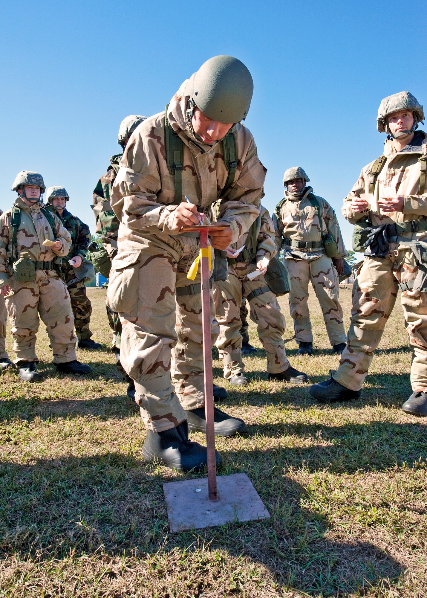 A senior airman with the 96th Air Base Wing uses his Airman’s Manual to determine the type of UXO found during a sweep of the area at the chemical, biological, radiological, nuclear and explosive training course at Eglin Air Force Base, Fla.  The eight-hour course combines computer based and hands-on training on how and when to wear the gear, unxploded ordnances and protective measures.  The 96th Civil Engineer Squadron’s emergency readiness flight teaches the hands-on course up to 75 times a year. (U.S. Air Force photo/ Samuel King Jr.)