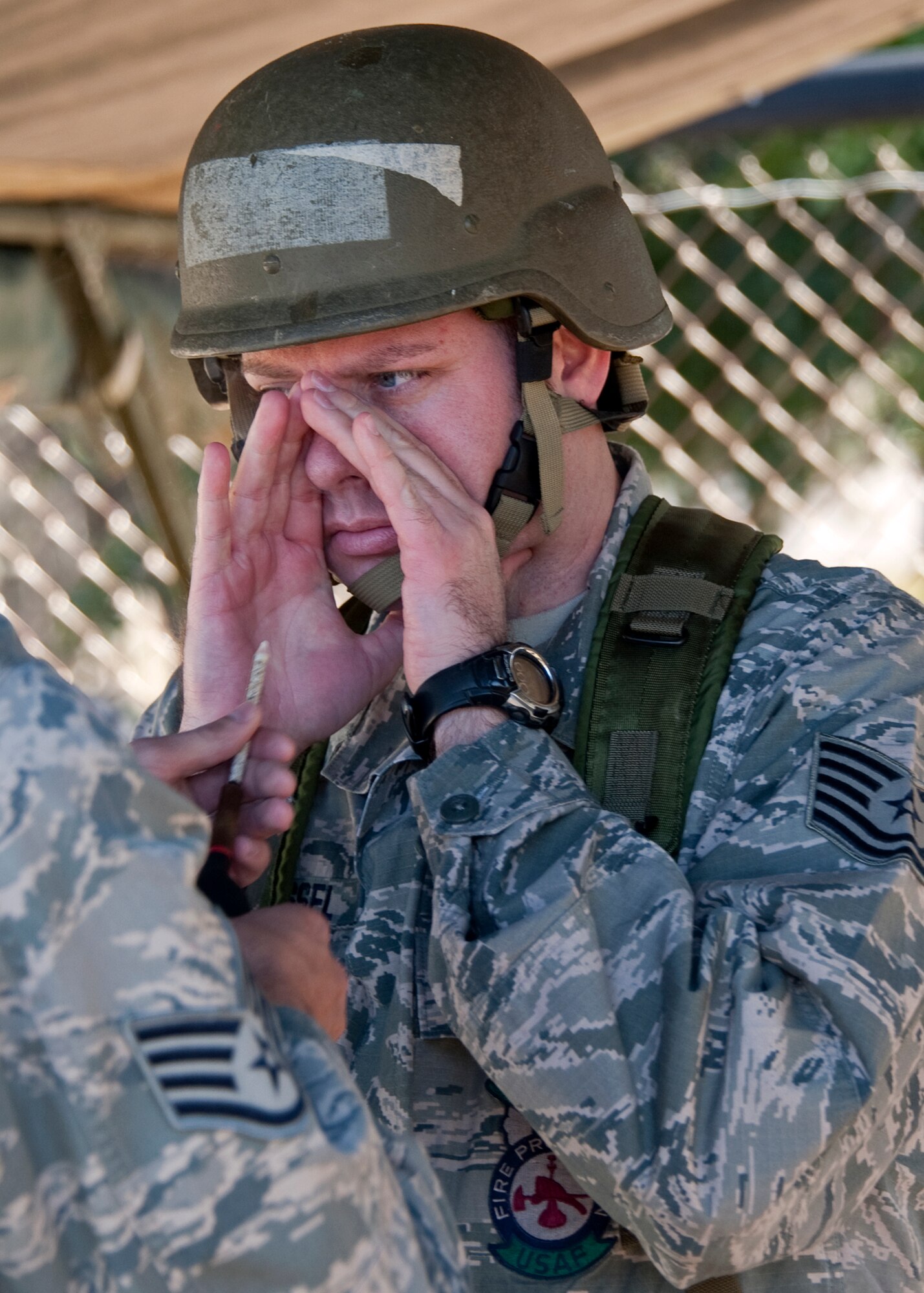 A technical sergeant prepares to breathe in the chemical irritant during the chemical, biological, radiological, nuclear and explosive training course at Eglin Air Force Base, Fla.  The eight-hour course combines computer based and hands-on training on how and when to wear the gear, unxploded ordnances and protective measures.  The 96th Civil Engineer Squadron’s emergency readiness flight teaches the hands-on course up to 75 times a year.   (U.S. Air Force photo/ Samuel King)