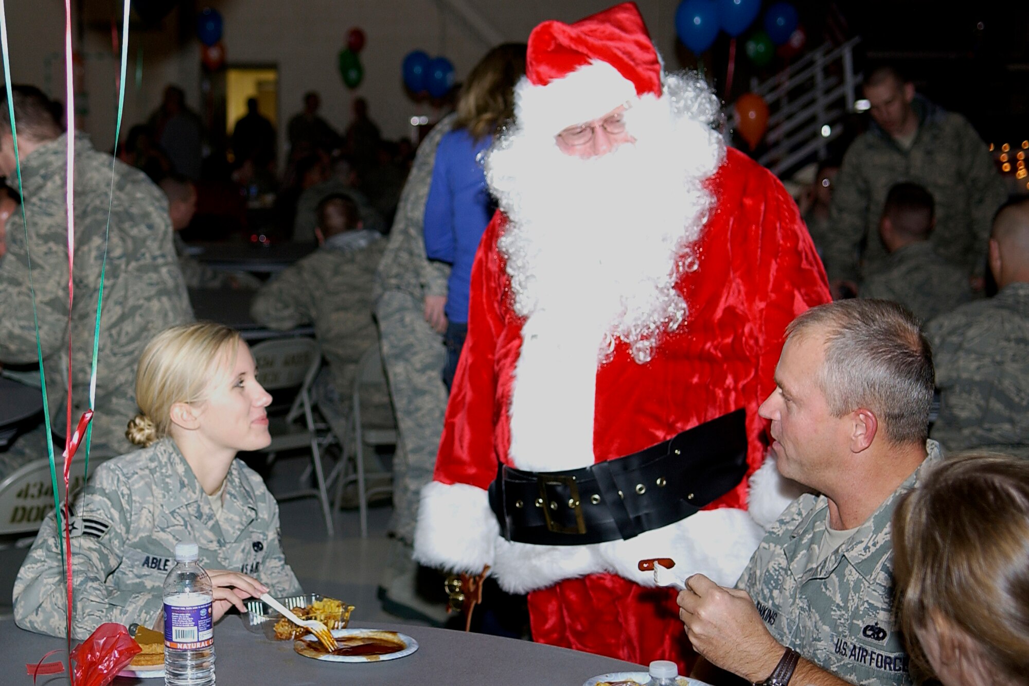 GRISSOM AIR RESERVE BASE, Ind. -- Santa Claus visits with Senior Airman Aubrey Able and Master Sgt. Larry Jenkins during the 434th Aircraft Maintenance Squadron Christmas party. Airman Able is an integrated avionics apprentice and Sergeant Jenkins is an avionics guidance control specialist. Both Airmen are assigned to the 434th AMXS. (U.S. Air Force photo/Senior Airman Damon Kasberg) 