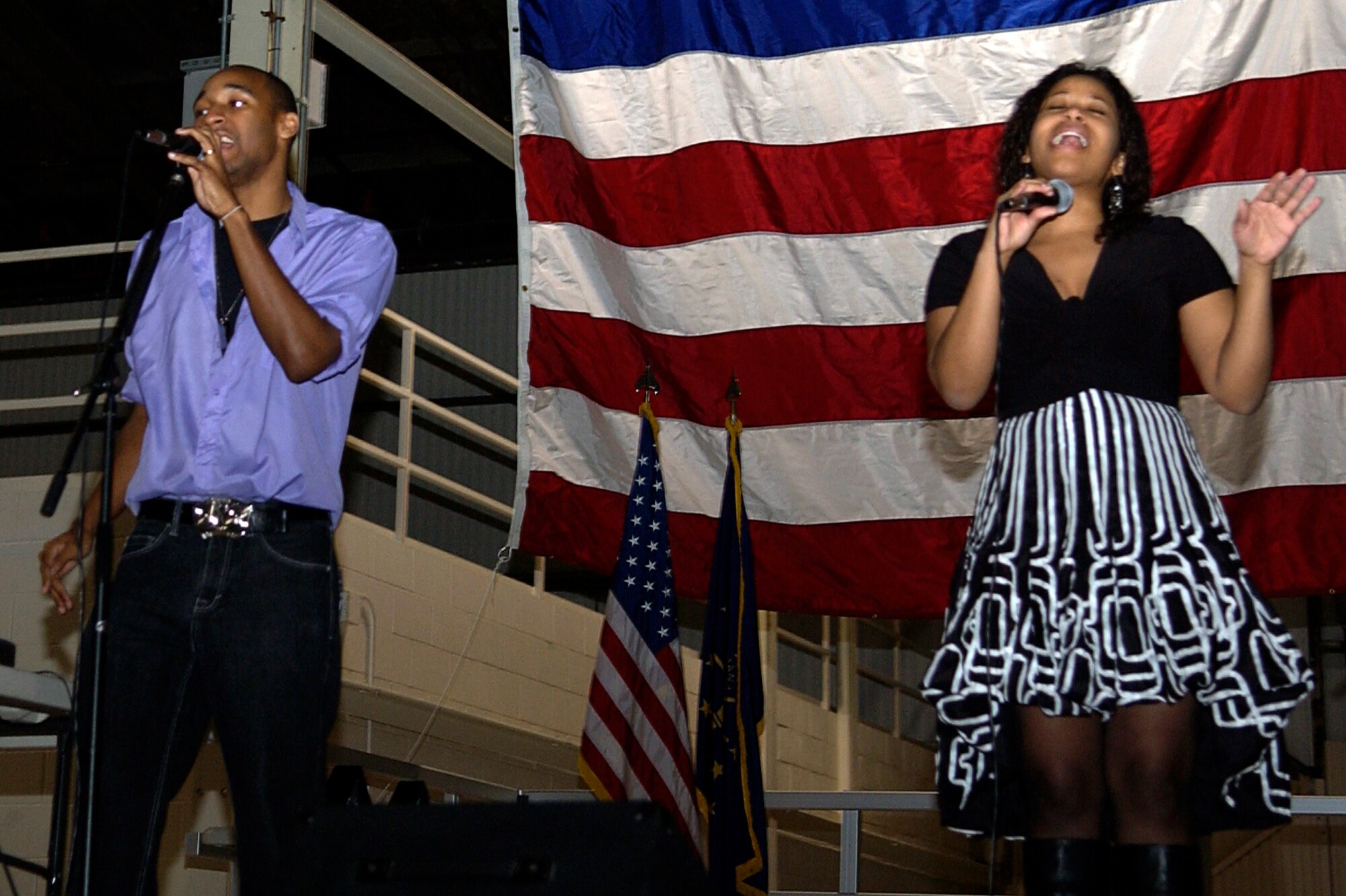 GRISSOM AIR RESERVE BASE, Ind. -- Raymond Silver and Latera Jenkins, part of the music group Danee, sing on stage during the 434th Aircraft Maintenance Squadron Christmas party held here during the December unit training assembly. (U.S. Air Force photo/Senior Airman Damon Kasberg) 