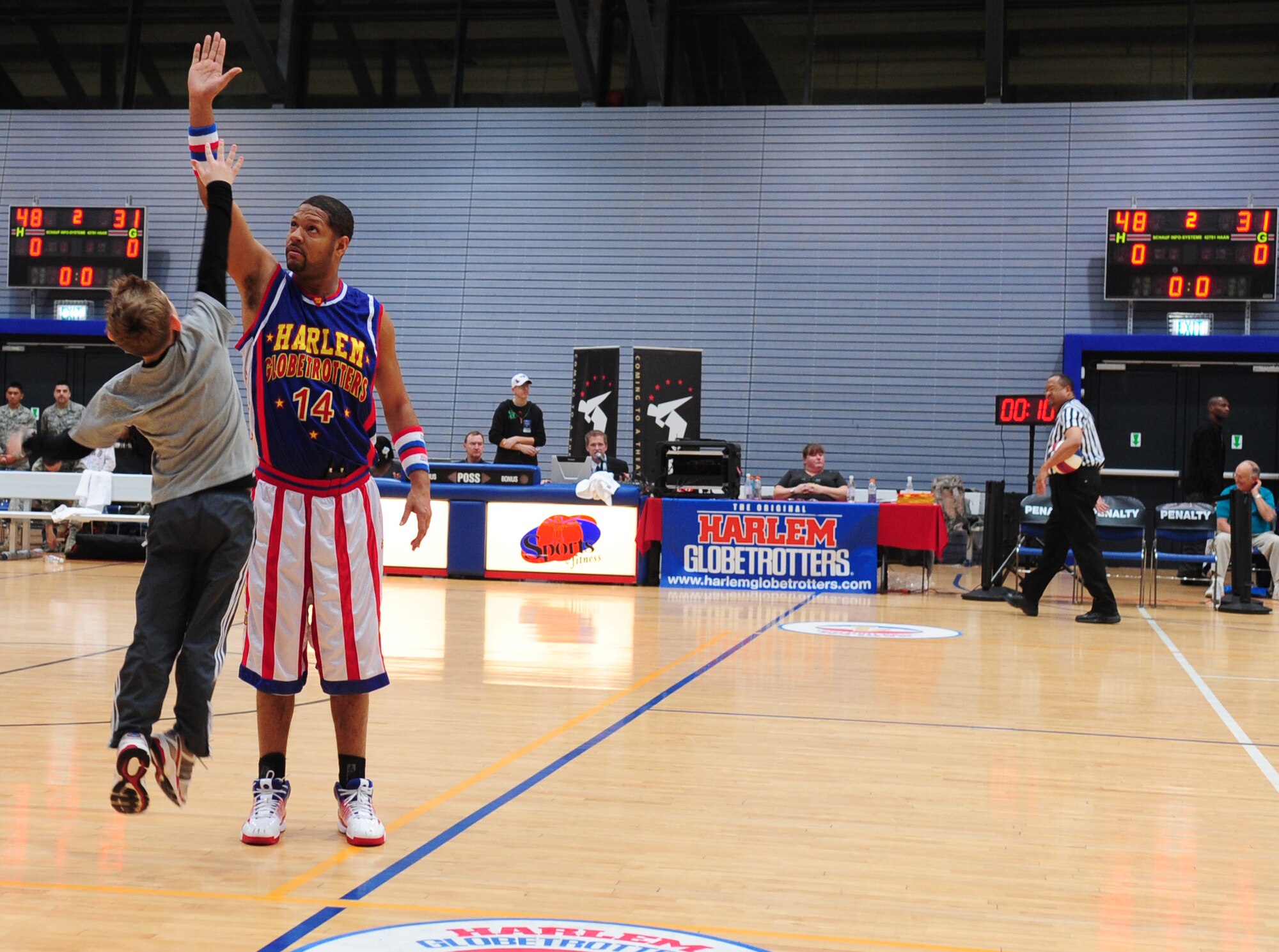Handles Franklin, Harlem Globetrotters member, offers a high-five to a young attendee during a Military Holiday tour, Ramstein Air Base, Germany, Dec. 8, 2010. This tour was made possible by Navy Entertainment and Armed Forces Entertainment; this year's tour will feature 11 games on U.S. military bases in five countries: Germany, Italy, Greece, the Netherlands and the United Kingdom.  The Globetrotters are celebrating their 85th year entertaining audiences around the world. (U.S. Air Force photo by Senior Airman Brittany Nicole Perry)