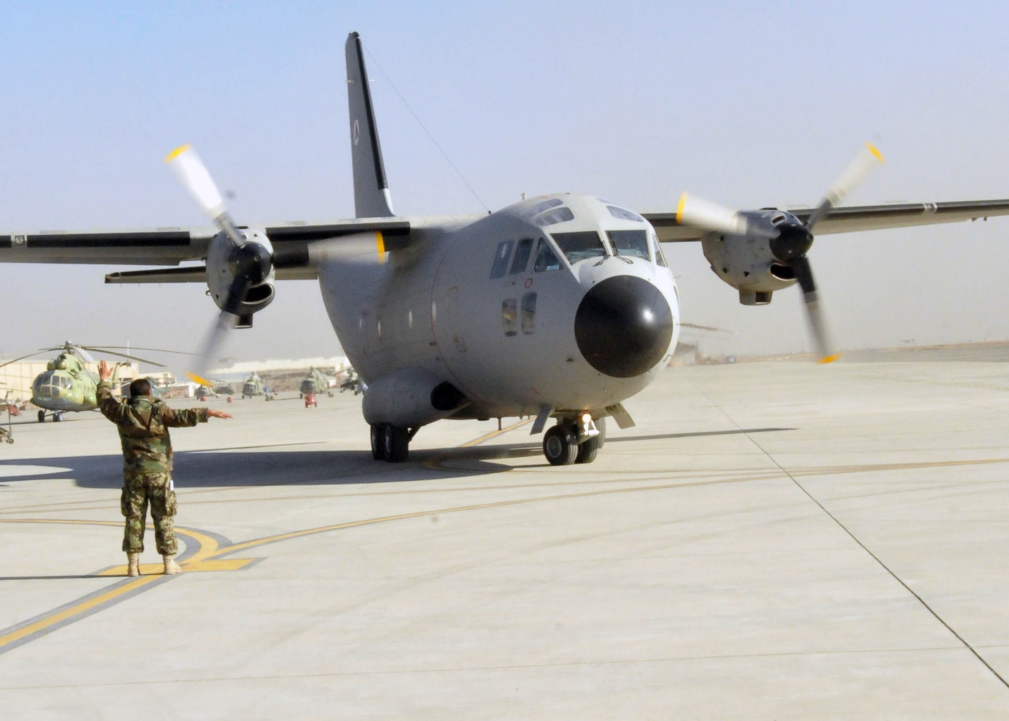101208-N-6541W-004 KABUL, Afghanistan - An Afghan Air Force members directs a C-27 Spartan on the flight line at the Afghan Air Force Base on the Kabul International Airport without advisor or contractor assistance, on Dec.  7. (U.S. Navy photo by Mass Communication Specialist 3rd Class Jared Walker/ RELEASED).