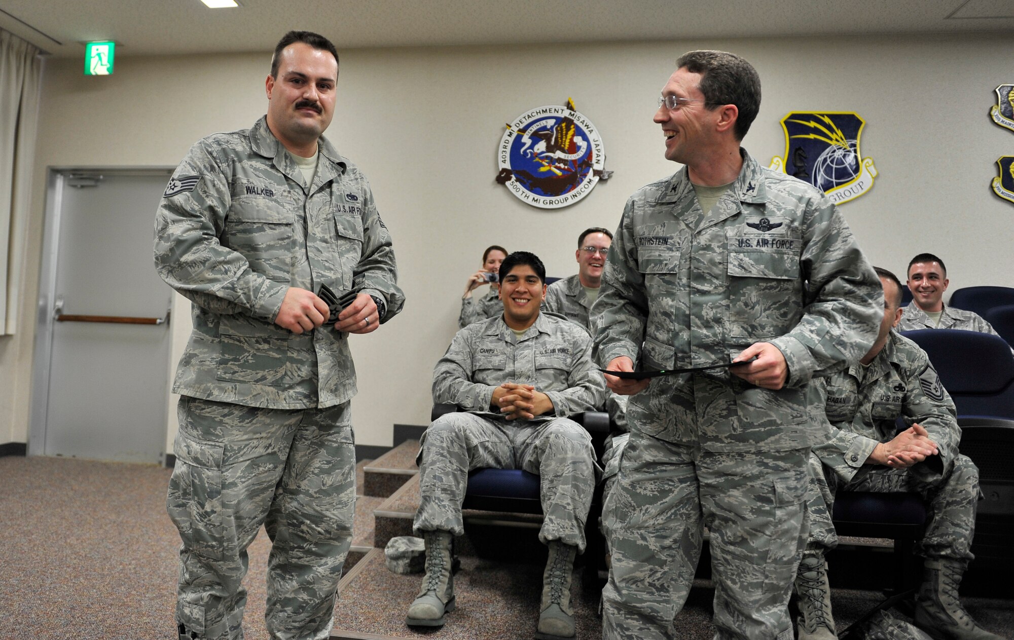 Staff Sgt. Carl Walker, 35th Maintenance Operations Squadron, accepts technical sergeant uniform stripes from Col. Michael Rothstein, 35th Fighter Wing commander, Dec. 9, 2010, during a surprise STEP promotion announcement at Misawa Air Base, Japan. Additionally, Staff Sgt. Vanessa Perner, 35th Communications Squadron, was selected for promotion to technical sergeant and was notified via telephone conference at her current location.  The stripes for exceptional performers program recognizes outstanding individuals instantly promoting them to technical or master sergeant. U.S Air Force photo by Staff Sgt. Chad Strohmeyer/Released)