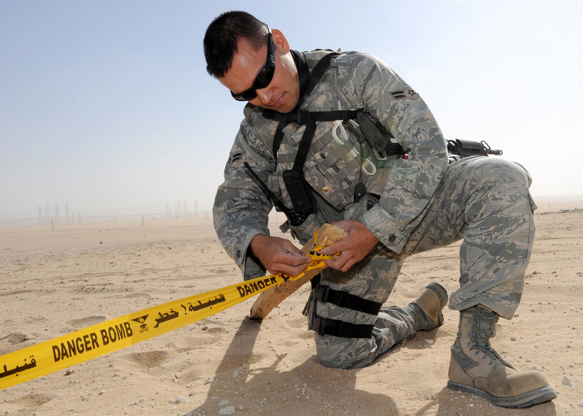 SOUTHWEST ASIA - Airman 1st Class Robert Jones, a 386th Expeditionary Security Forces Squadron patrolman and Viper Team member, cordons off an area where a local national pointed out a possible Unexploded Ordnance near an undisclosed air base Nov. 29, 2010. Viper Teams patrol outside the base perimeter, looking for anything out of the ordinary that might pose a threat to Airmen here. (U.S. Air Force photo by Senior Airman Laura Turner)