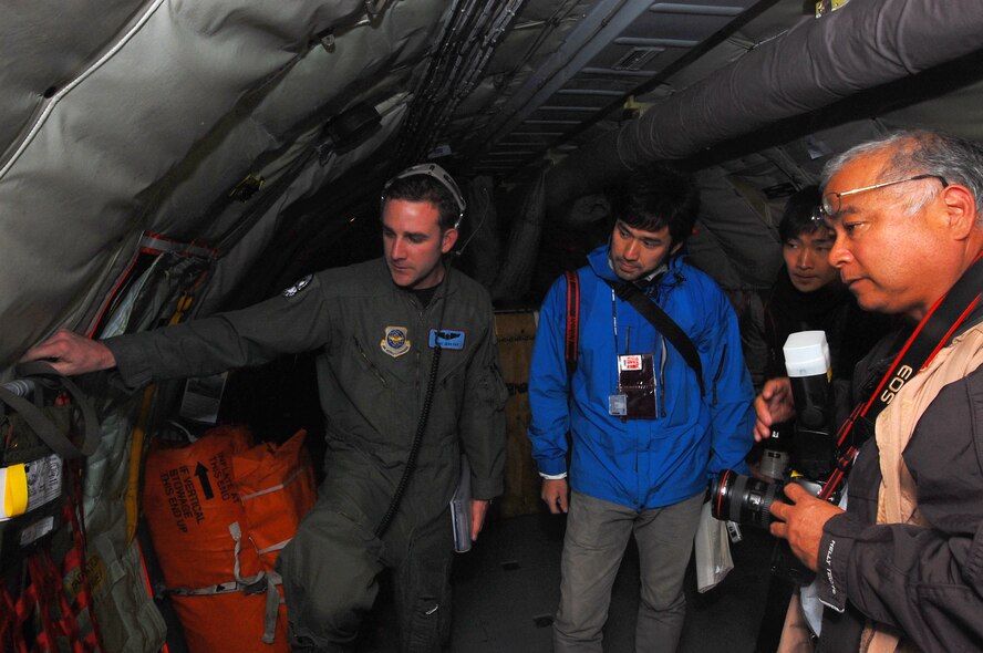 Technical Sgt. Jess Cox, a boom operator with the 185th Air Refueling Squadron, Oklahoma Air National Guard, Tinker Air Force Base discusses safety procedures to local national media before take-off during the Keen Sword exercise here at Kadena Air Base, Japan, Dec. 8. Keen Sword 2011 will include an estimated 10,500 U.S. participants from the Army, Navy, Air Force and Marines. Significant training events during Keen Sword 2011 will include integrated air and missile defense, base security and force protection, search and rescue, close air support, live-fire training, and maritime defense and interdiction. ( U.S. Air Force photo/ Staff Sgt. Lakisha A. Croley)