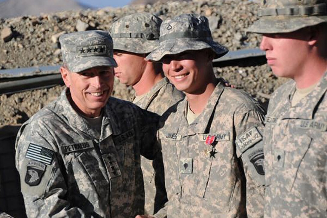 U.S. Army Gen. David H. Petraeus International Security Assistance Force commander, shakes the hand of U.S. Army Spc. Timothy James of Gilbert, Ariz., after pinning him with a Bronze Star Medal with Valor at Combat Outpost Margah, Nov. 11, 2010. James, an infantryman with Company C, 2nd Battalion, 506th Infantry Regiment, 4th Brigade Combat Team, 101st Airborne Division, received the medal and a battlefield promotion from private first class to specialist for his actions during an Oct. 30 attack. U.S. Army photo by Sgt. Maj. Hector Santos
