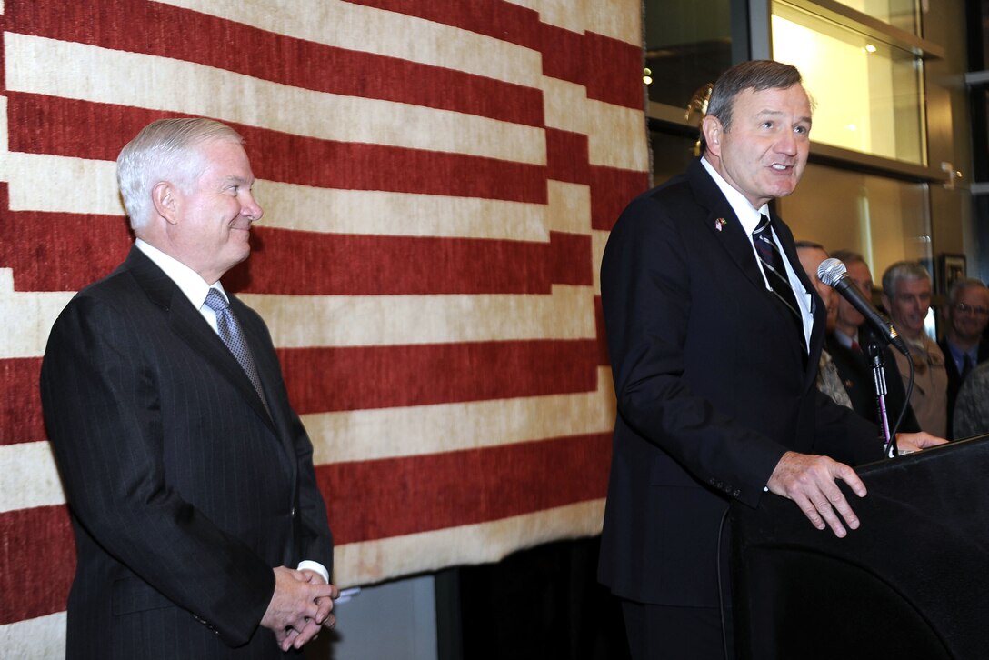 U.S. Ambassador to Afghanistan Karl Eikenberry, right, introduces U.S. Defense Secretary Robert M. Gates at the U.S. Embassy in Kabul, Afghanistan, Dec. 9, 2010. 
