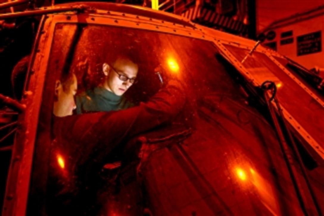 U.S. Navy Airman Joseph Clemson troubleshoots electronics on an SH-60F Seahawk helicopter aboard the aircraft carrier USS Carl Vinson (CVN 70) in the Pacific Ocean on Dec. 3, 2010.  The Carl Vinson is on a three-week composite training unit exercise followed by a deployment to the western Pacific Ocean.  Clemson, an aviation electronics technician, is assigned to Helicopter Anti-Submarine Squadron 15.  