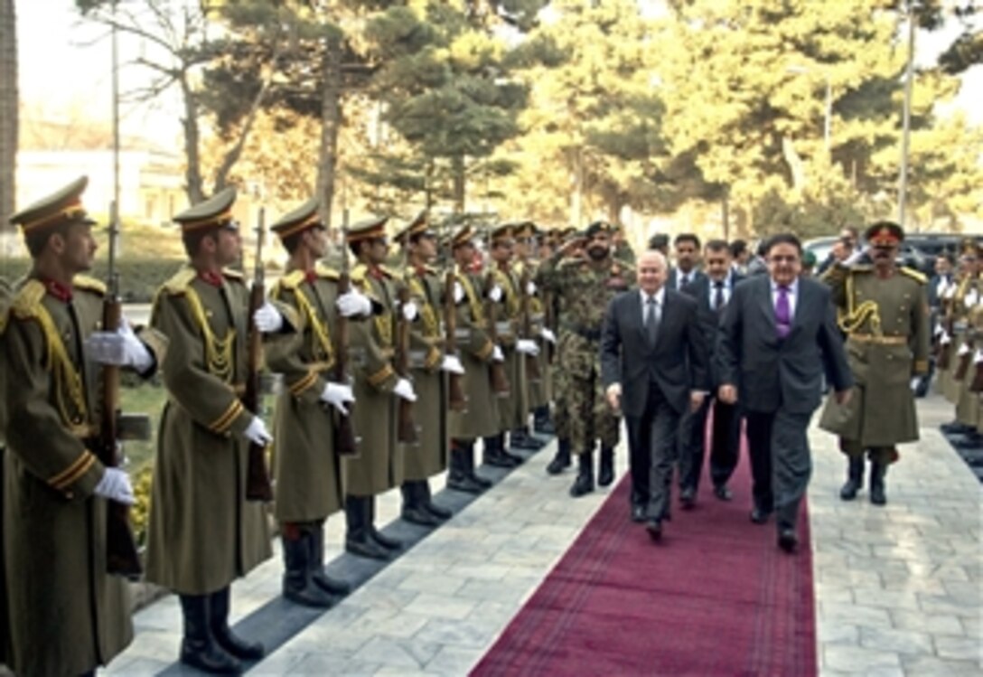 Secretary of Defense Robert M. Gates receives an honors welcome as he walks with Afghan Defense Minister Abdul Rahim Wardak at the Ministry of Defense in Kabul, Afghanistan, on Dec. 9, 2010.  
