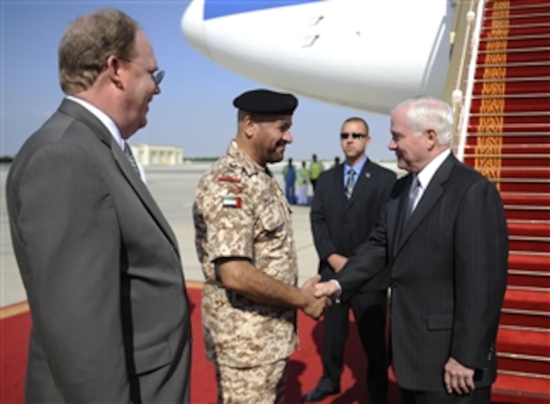 Secretary of Defense Robert M. Gates is greeted by United Arab Emirates Gen. Shaikh Mohammad Bin Zayed and U.S. Embassy Charge d' Affaires Douglas Greene after arriving in Abu Dhabi on Dec. 9, 2010.  