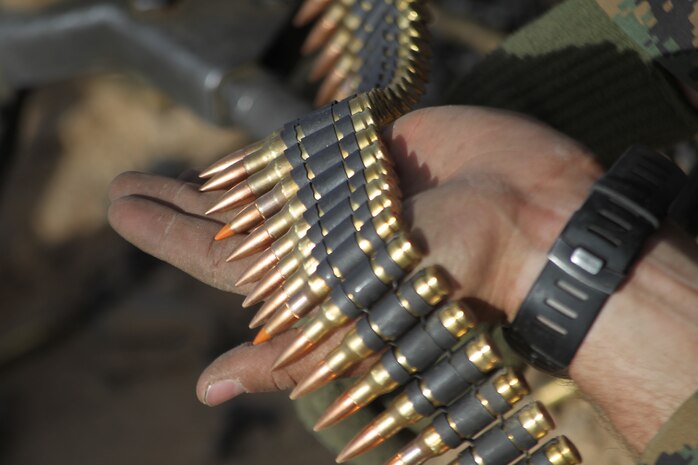 An student with the Infantry Officer’s Course, feeds ammunition into a 240B machine gun Dec. 10, 2010, at Combat Center Range 205. The class is based out of Marine Corps Base Quantico, Va., and trains Marines aboard the Combat Center four times a year.::r::::n::