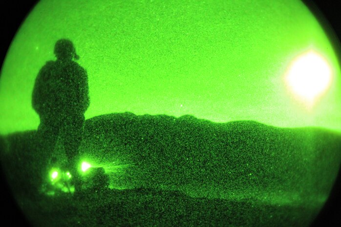 An Infantry Officer Course instructor monitors his students laying down suppressive fire ata a machine gun nest during a night attack at the Combat Center Dec. 10, 2010. The night attack is part of the students' culminating event before graduating at Marine Corps Base Quantico, Va.