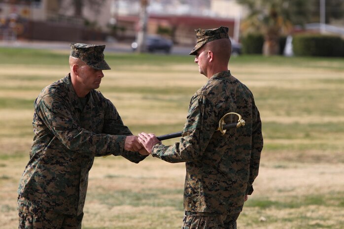 Sergeant Maj. Eric W. Rummel, the outgoing battalion sergeant major of 2nd Battalion, 7th Marine Regiment, passes the noncommissioned officer’s sword to Lt. Col. John M. Reed, the battalion commanding officer, during a relief and appointment ceremony at Lance Cpl. Torrey L. Gray Field, Dec. 10, 2010.