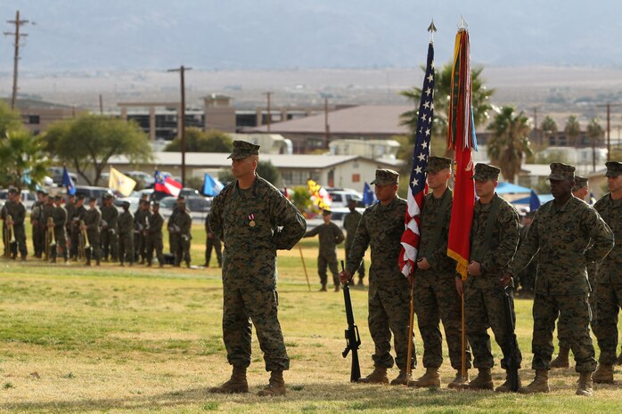 Sergeant Maj. Eric W. Rummel, the outgoing battalion sergeant major of 2nd Battalion, 7th Marine Regiment, stands before Marines, sailor, family and friends as Lt. Col. John M. Reed, the battalion commanding officer speaks about his service during  a relief and appointment ceremony at Lance Cpl. Torrey L. Gray Field, Dec. 10, 2010. ::r::::n::