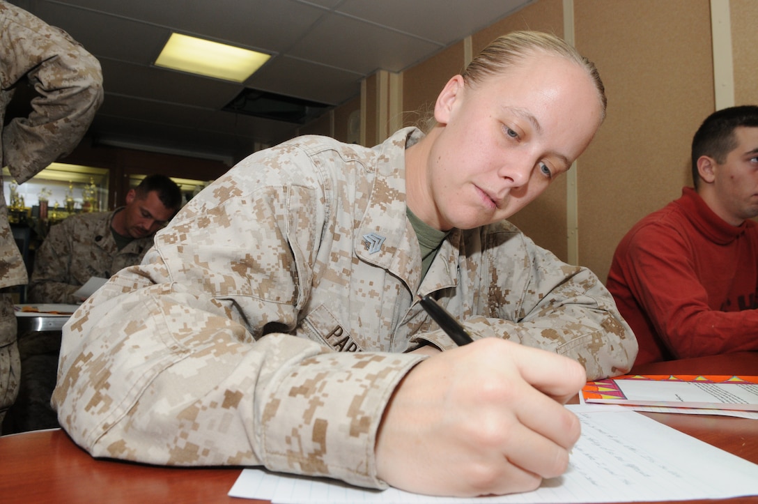 Sergeant Deanna Parker with Combat Logistics Battalion 26, 26th Marine Expeditionary Unit, responds to a letter written by an elementary school student at Assumption Catholic School in O’Fallon, MO. 26th MEU Marines and sailors aboard USS Kearsarge volunteered to respond to 88 letters sent from Assumption Catholic and North Asheville Christian School in Asheville, N.C. “These letters are very encouraging, and it will be something that I will keep forever," said Parker. "One thing the girl put in the letter really stood out to me: ‘give someone a hand and you will both climb higher.’ I could just tell the girl who wrote this really put some thought into it.”