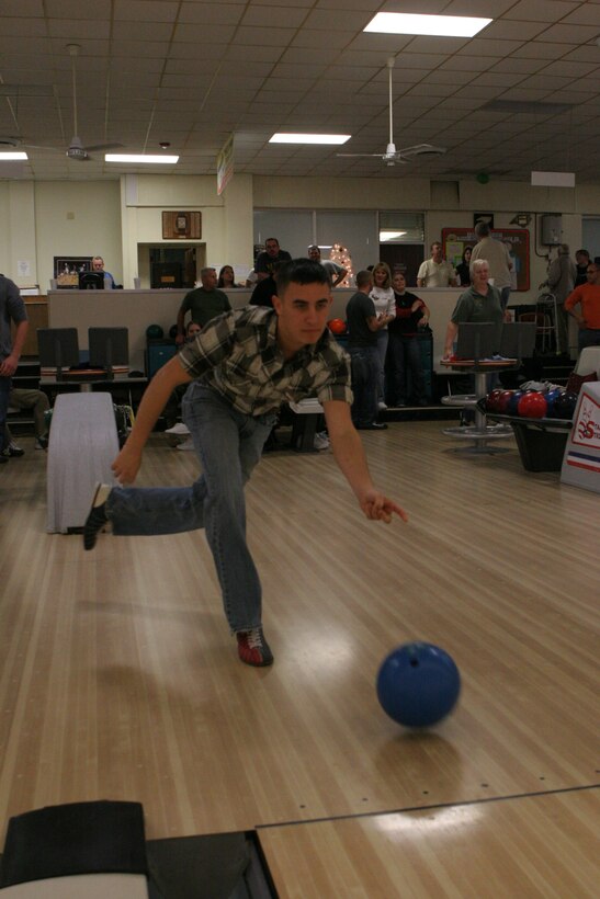Stowers throws his bowling ball down the lane at the Stars N’ Strikes Bowling Alley during the Toys for Tots toy drive Dec. 10.