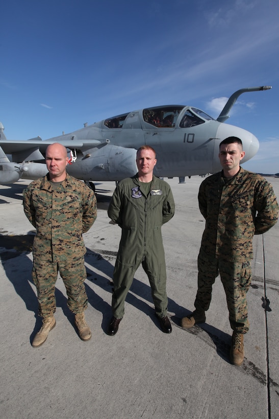 Capt. Joshua W. Weiland, center, stands in front of an EA-6B Prowler Dec. 10 with Marines he served with as an enlisted man. Weiland joined the Marine Corps in 1996 and was assigned to VMAQ-4 as an EA-6B Prowler aircraft technician. After four years of service, Weiland got out of the Marine Corps, went to college, and then came back into the Marine Corps as an officer in 2003. After flight school, Weiland found himself back where he’d served seven years before, with VMAQ-4.