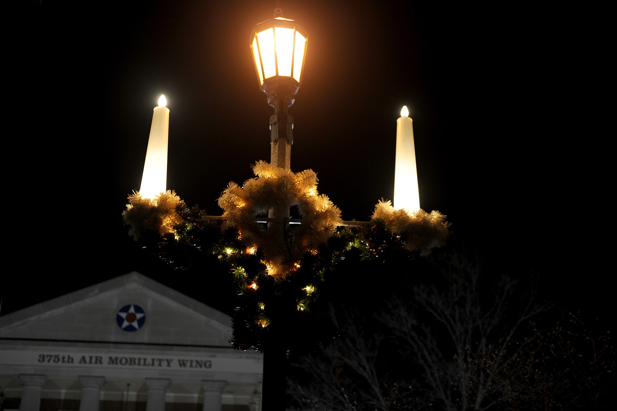 Christmas decorations hang from a light post in front of the 375th Air Mobility Wing headquarters building, Dec. 10, 2010. Members of team Scott decorated around the base to show their holiday spirit. (U.S. Air Force photo by Staff Sgt. Brian J. Valencia)