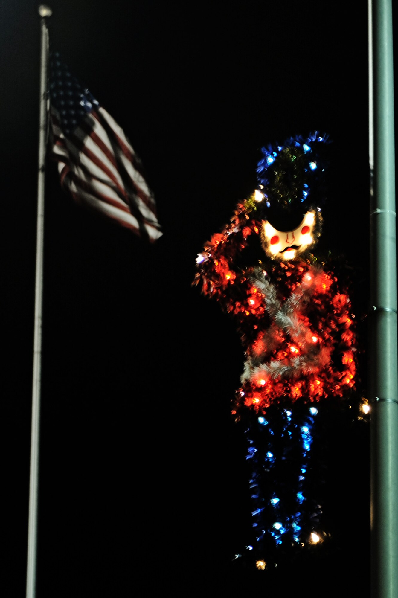 A little drummer boy Christmas decoration hangs from a light post on Scott Dr., Dec. 10, 2010. Members of team Scott decorated around the base to show their holiday spirit. (U.S. Air Force photo by Staff Sgt. Brian J. Valencia)