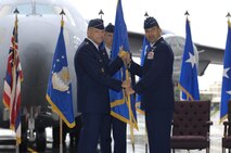 Gen. Gary North (left), Pacific Air Forces commander, presents Lt. Gen. Ted Kresge with the 13th Air Force unit flag during the a change of command ceremony at Joint Base Pearl Harbor Hickam, Hawaii, on Dec. 10, 2010.  Lt.  Gen. Hawk  Carlisle relinquished command of 13th Air Force to Lt. Gen. Ted Kresge during the ceremony presided over by General North. 