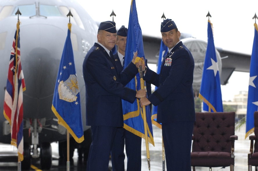 Gen. Gary North (left), Pacific Air Forces commander, presents Lt. Gen. Ted Kresge with the 13th Air Force unit flag during the a change of command ceremony at Joint Base Pearl Harbor Hickam, Hawaii, on Dec. 10, 2010.  Lt.  Gen. Hawk  Carlisle relinquished command of 13th Air Force to Lt. Gen. Ted Kresge during the ceremony presided over by General North. 