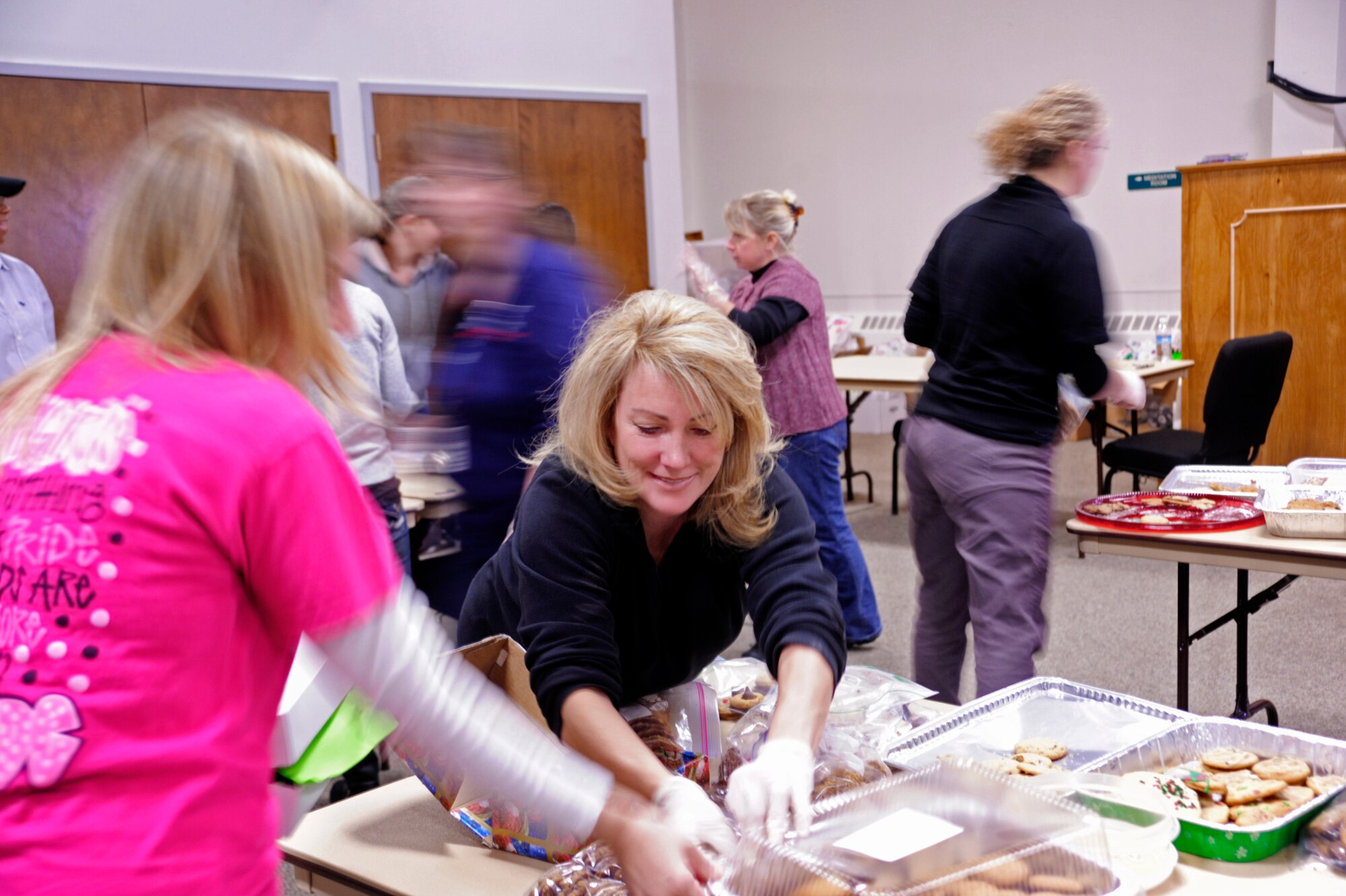 McChord spouses quickly package a large number of cookies and other holiday treats Dec. 10 during the annual McChord cookie drop, hosted by the Chapel Support Center at McChord Field, Joint Base Lewis-McChord, Wash. According to representatives at the CSC, the number of cookies donated this year exceeded last year’s. (U.S. Air Force photo/Adamarie Lewis-Page)