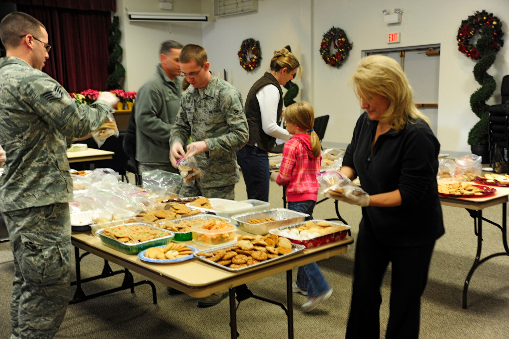 McChord Airmen, spouses and USO volunteers package cookies and other holiday treats Dec. 10 during the annual McChord cookie drop, hosted by the Chapel Support Center at McChord Field, Joint Base Lewis-McChord, Wash. More than 400 bags were prepared to be distributed by squadron first sergeants to single Airmen living in the dorms. (U.S. Air Force photo/Adamarie Lewis-Page)