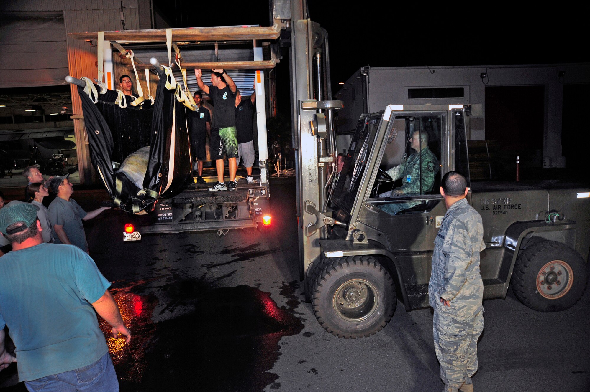 An Airman with the Puerto Rico Air National Guard in San Juan, Puerto Rico, operates a forklift holding a wounded manatee while volunteers assist in transferring it into a vehicle Dec 9, 2010.  The manatee was transported from MacDill Air Force Base, Fla., to San Juan on a C-130 Hercules flown by an aircrew from the Puerto Rico Air Guard’s 156th Airlift Wing. (U.S. Air Force photo/Staff Sgt. Angela Ruiz)