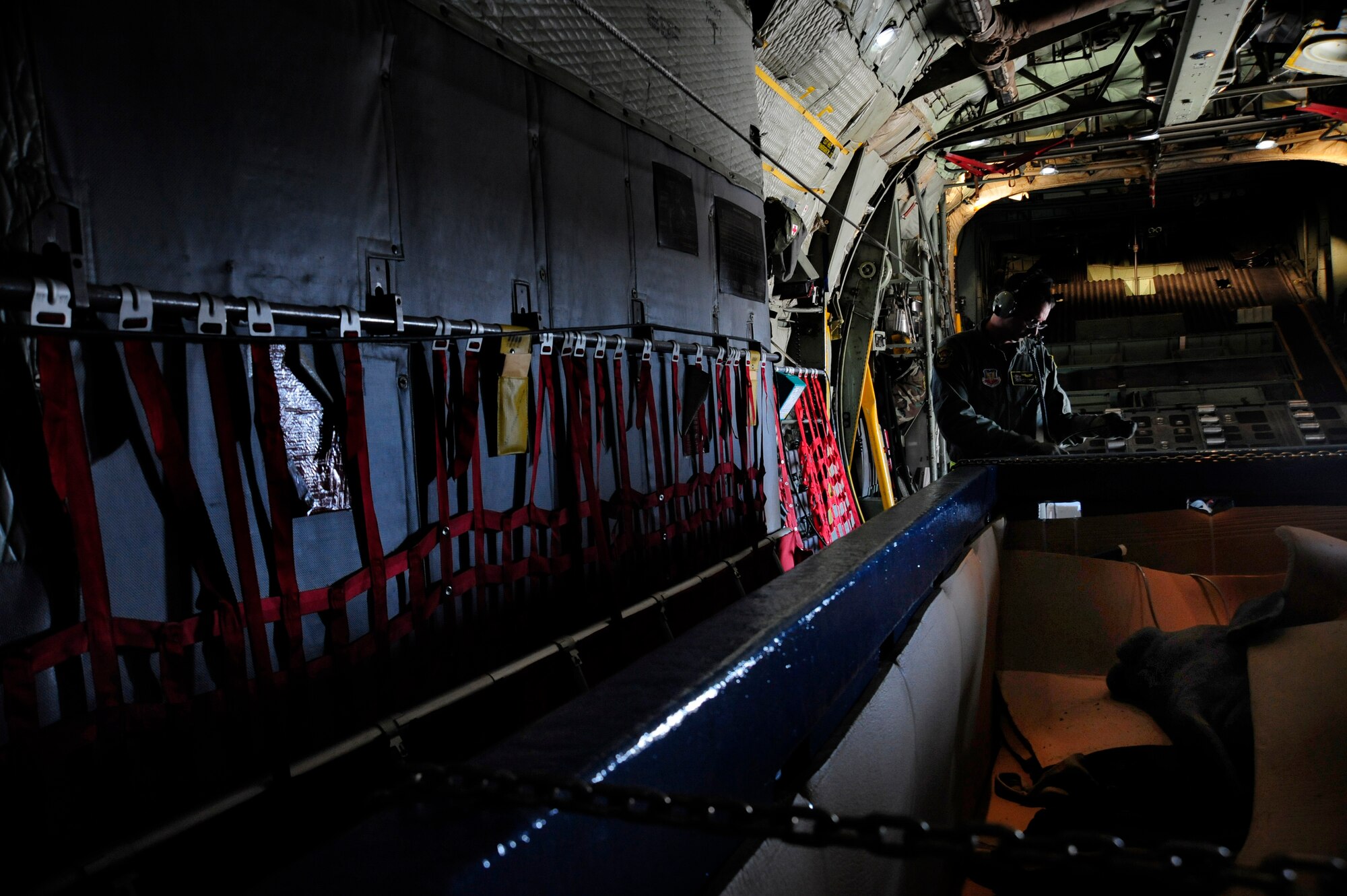 Staff Sgt. Joan Rosario-Torres, Puerto Rico Air National Guard C-130 loadmaster, listens for instructions over his headset before the C-130 with Guacara a wounded manatee takes off from MacDill Air Force Base, Fla., Dec 9, 2010. Guacara Suffered minor injuries in a boat strike and will be transported to the Puerto Rico Zoo where he will placed in his new home. (U.S. Air Force photo by: Staff Sgt. Angela Ruiz)