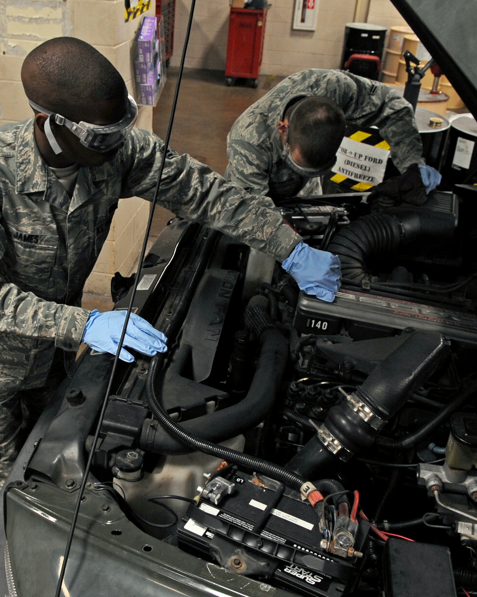 Senior Airman James Leonard, 917th Logistic Readiness Squadron  reservist material handling equipment manager and Airman 1st Class Scott Silvester, 2nd LRS vehicle and equipment maintenance apprentice, performs an overall inspection of a Dodge Bobtail on Barksdale Air Force Base, La., Dec. 10. An overall inspection consists of fluid checks, hoses, corrosion and visual. The 2 LRS vehicle maintenance facility is responsible for more than 800 of Barksdale's government vehicles. (U.S. Air Force Photo/Senior Airman La'Shanette V. Garrett)(RELEASED)