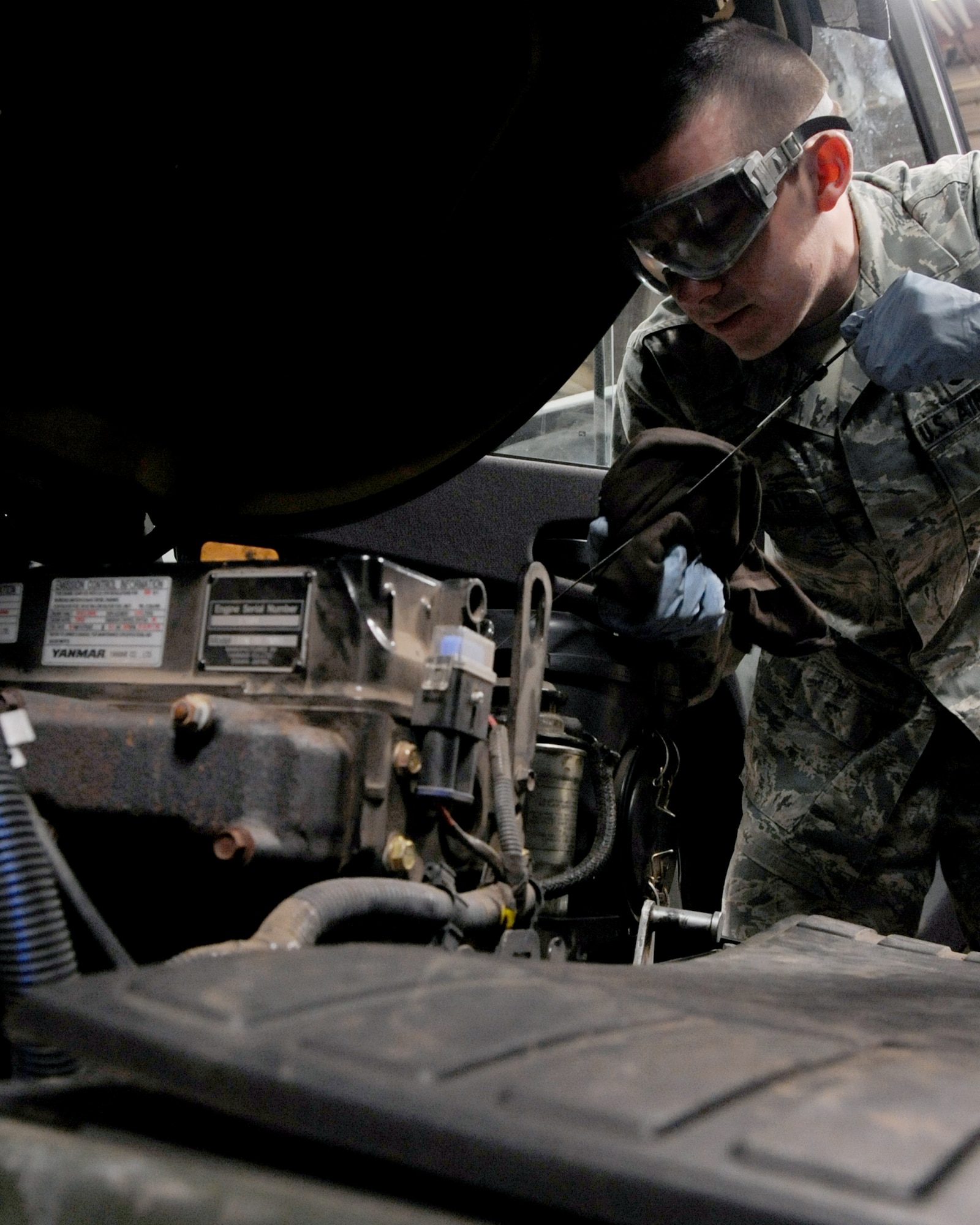 Airman 1st Class Scott Silvester, 2nd Logistic Readiness Squadron vehicle and equipment maintenance apprentice, checks the oil of a Dodge Bobtail during an overall inspection on Barksdale Air Force Base, La., Dec. 10. An overall inspection consists of fluid, hose, corrosion and visual checks. The 2 LRS vehicle maintenance facility is responsible for more than 800 of Barksdale's government vehicles. (U.S. Air Force Photo/Senior Airman La'Shanette V. Garrett)(RELEASED)