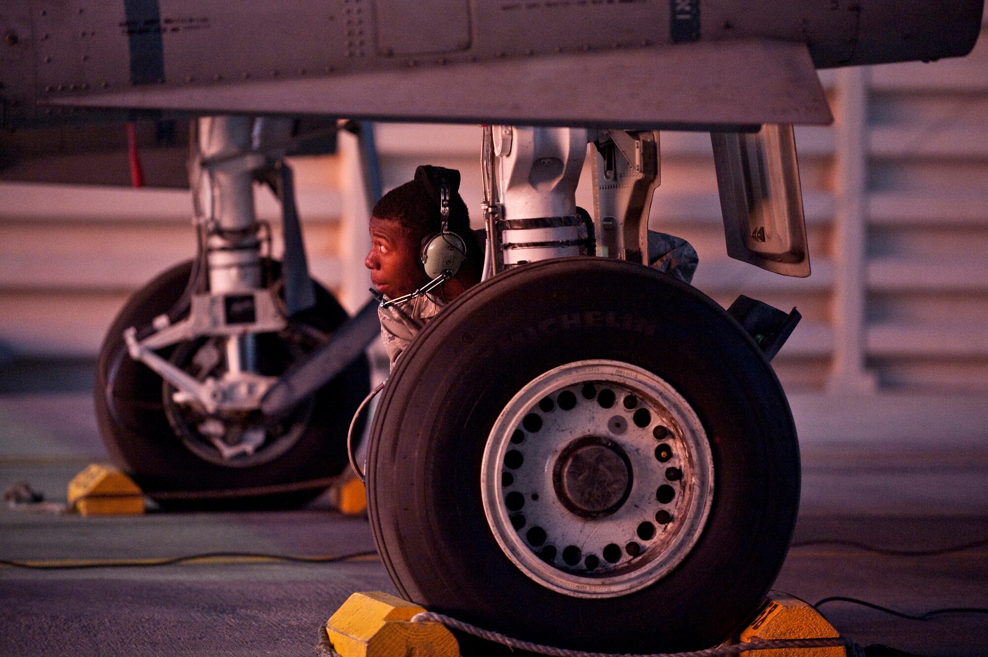 NELLIS AIR FORCE BASE, Nev. -- Senior Airman Edwin Watkins, a crew chief with the 23rd Aircraft Maintenance Squadron from Moody Air Force Base, Ga., looks over the landing gear of an A-10 Thunderbolt II before a training mission during the Green Flag West 11-2 exercise at Nellis Dec. 10. Green Flag-West provides a realistic air-land integration training environment for forces preparing to support worldwide combat operations. (U.S. Air Force photo by Tech. Sgt. Michael R. Holzworth)
