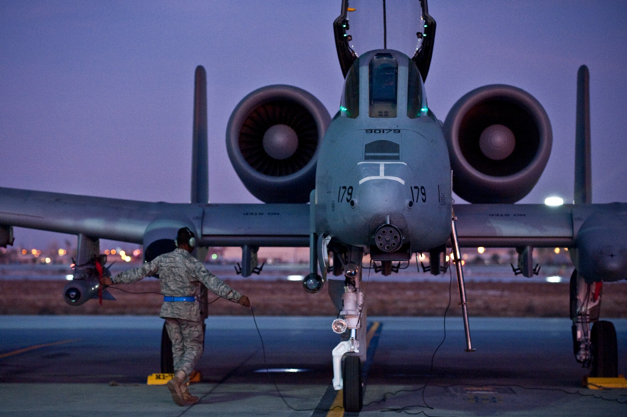 NELLIS AIR FORCE BASE, Nev. -- Senior Airman Edwin Watkins, a crew chief with the 23rd Aircraft Maintenance Squadron from Moody Air Force Base, Ga., conducts pre-flight checks on an A-10 Thunderbolt II before a training mission during the Green Flag West 11-2 exercise at Nellis Dec. 10. Green Flag-West provides a realistic air-land integration training environment for forces preparing to support worldwide combat operations. (U.S. Air Force photo by Tech. Sgt. Michael R. Holzworth)
