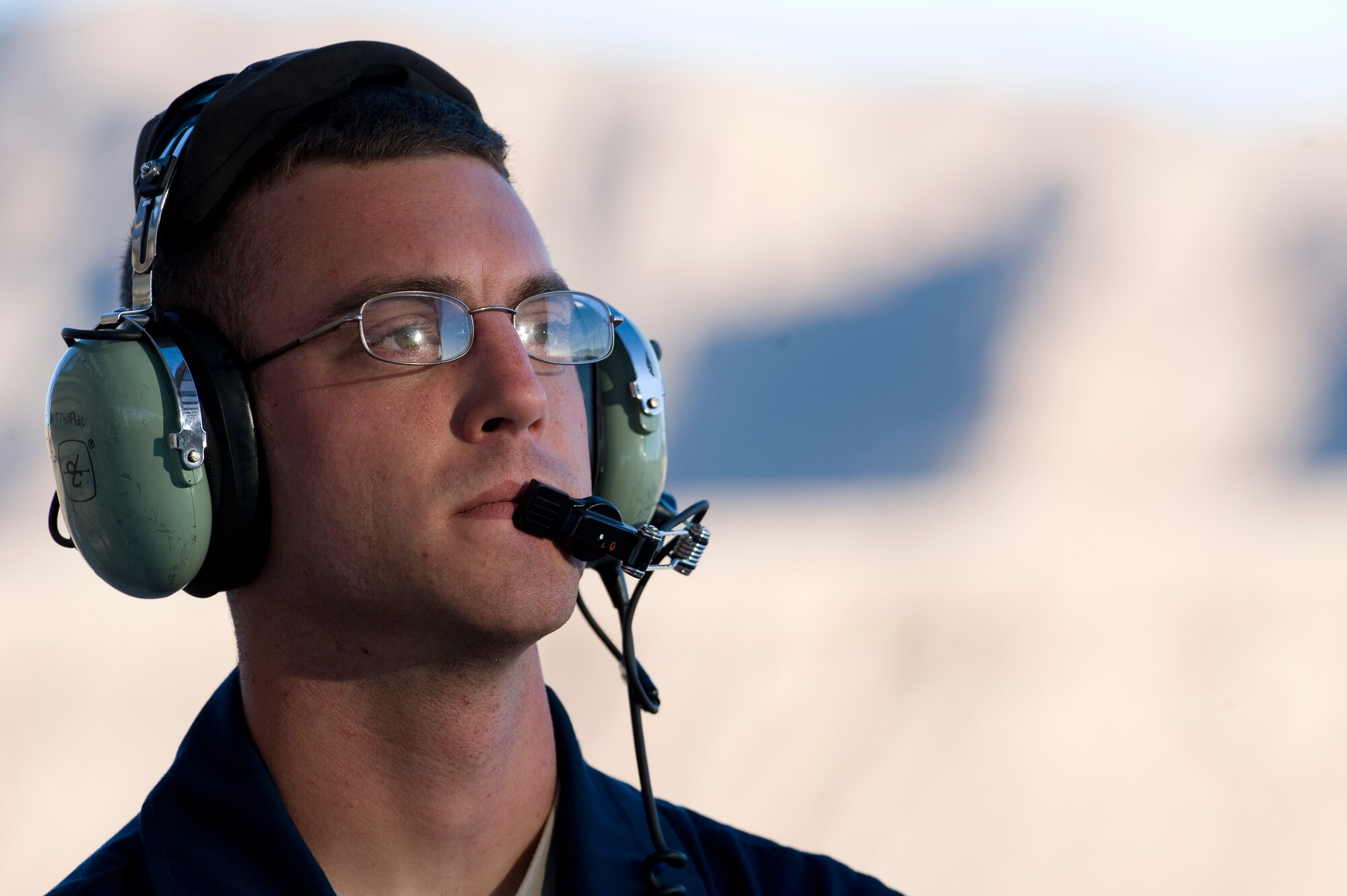 NELLIS AIR FORCE BASE, Nev. -- Staff Sgt. Robert Cooper, a crew chief with the 23rd Aircraft Maintenance Squadron from Moody Air Force Base, Ga., waits to marshal out an A-10 Thunderbolt II during Green Flag West 11-2 exercise at Nellis Dec. 6. Green Flag-West provides a realistic air-land integration training environment for forces preparing to support worldwide combat operations. (U.S. Air Force photo by Senior Airman Brett Clashman)