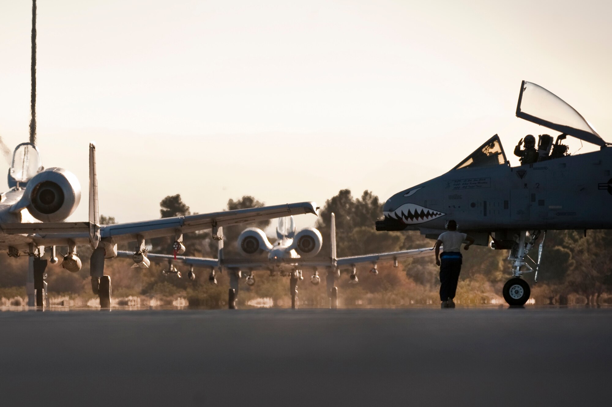 NELLIS AIR FORCE BASE, Nev. -- Three A-10 Thunderbolt II aircraft from the 74th Fighter Squadron, Moody Air Force Base, Ga., taxi toward the end on the Nellis runway for a training mission during the Green Flag West 11-2 exercise at Nellis Dec. 6. Green Flag-West provides a realistic air-land integration training environment for forces preparing to support worldwide combat operations. (U.S. Air Force photo by Tech. Sgt. Michael R. Holzworth)
