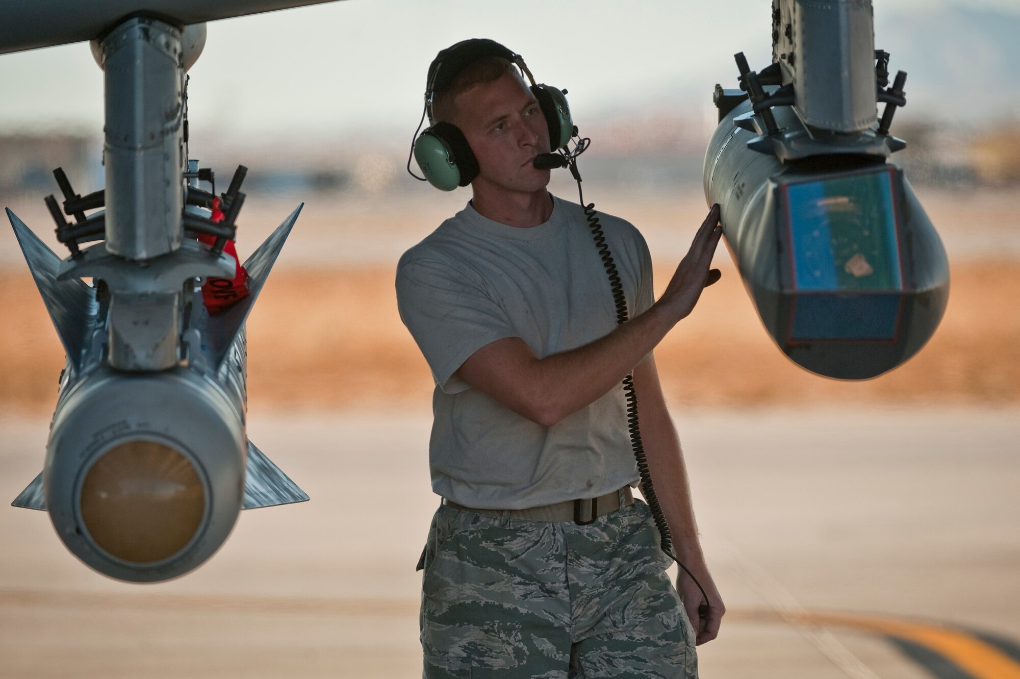 NELLIS AIR FORCE BASE, Nev. -- Staff Sgt. Jamie Case, a crew chief with the 23rd Aircraft Maintenance Squadron from Moody Air Force Base, Ga., conduct pre-flight checks on a targeting pod attached to an A-10 Thunderbolt II during the Green Flag West 11-2 exercise at Nellis Dec. 6. Green Flag-West provides a realistic air-land integration training environment for forces preparing to support worldwide combat operations. (U.S. Air Force photo by Tech. Sgt. Michael R. Holzworth)