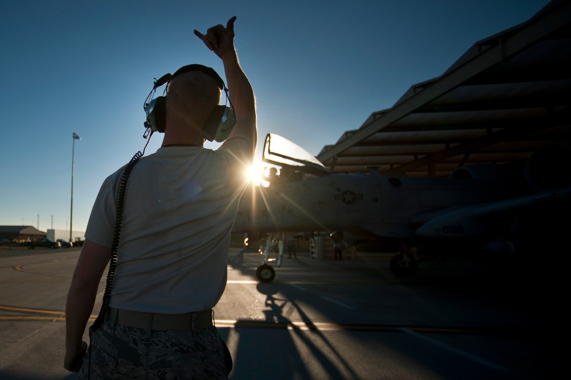 NELLIS AIR FORCE BASE, Nev. -- Staff Sgt. Jamie Case, a crew chief with the 23rd Aircraft Maintenance Squadron wishes Capt. John Meyers of the 74th Fighter Squadron luck as he departs on a late afternoon training mission in an A-10 Thunderbolt II during the Green Flag West 11-2 exercise at Nellis Dec. 6. Sergeant Case and Capt. Meyers are from Moody Air Force Base, Ga., and are deployed to Nellis in support of Green Flag-West. Green Flag-West provides a realistic air-land integration training environment for forces preparing to support worldwide combat operations. (U.S. Air Force photo by Tech. Sgt. Michael R. Holzworth)