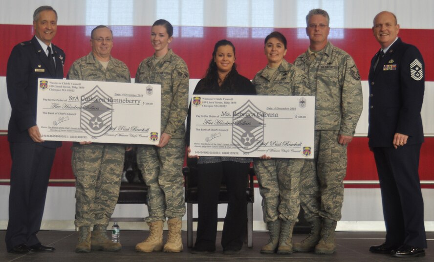 The Chiefs Council awarded two scholarship winners during the December Commander's Call (each received $500 from the council): Senior Airman Cathleen Henneberry, 439th Force Support Squadron and Rebecca Cabana. Pictured are, from left, Col. Robert Swain, 439th Airlift Wing commander; Chief Master Sgt. David Carbin, 439th Communications Squadron, Airman Henneberry, Ms. Cabana, Master Sgts. Luisa and David Cabana and Command Chief Master Sgt. Zigmund Skawski. (US Air Force photo/Tech. Sgt. Brian Boynton)