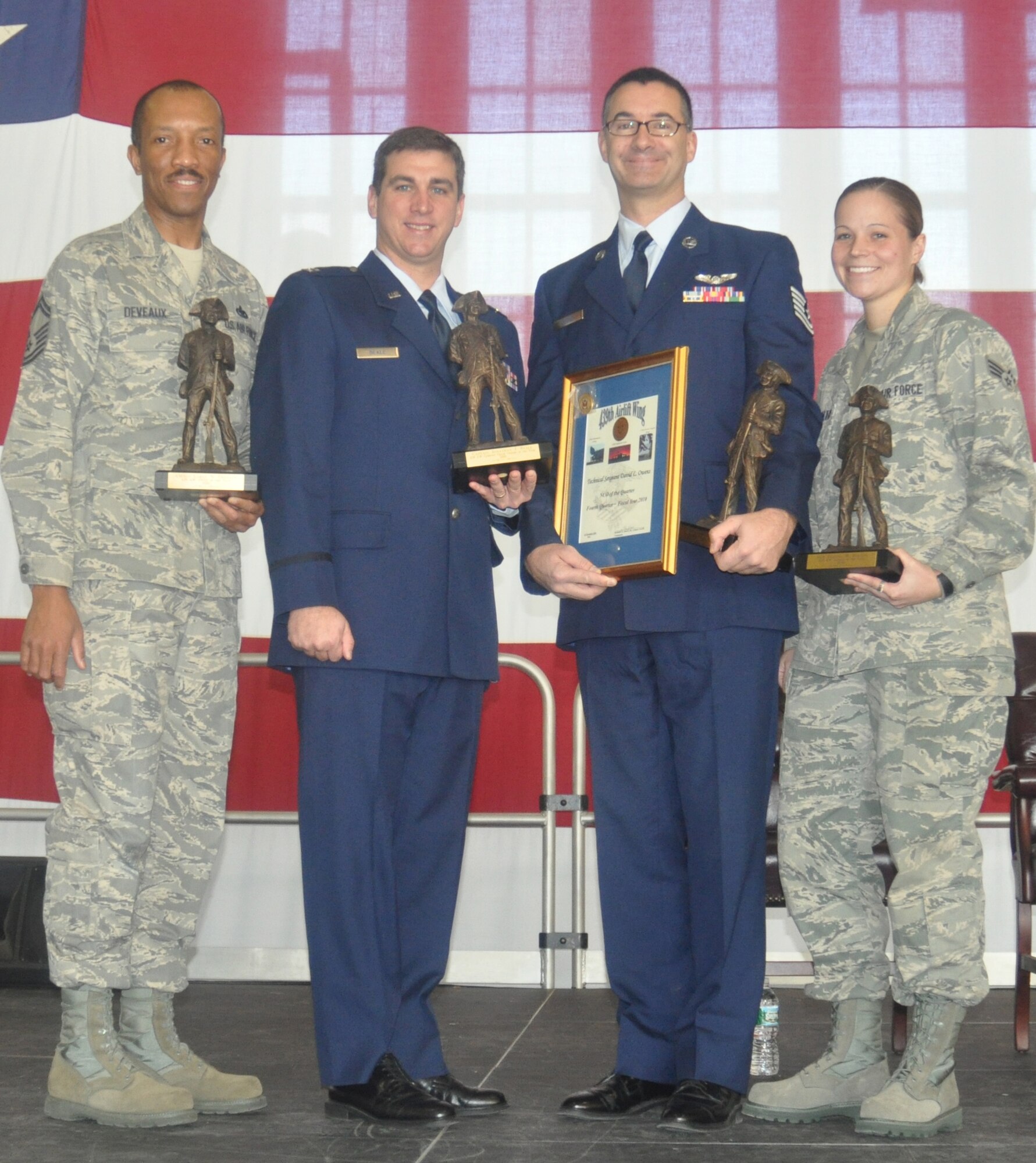 The annual awards winners for the 439th Airlift Wing for 2010 are, from left: Senior Master Sgt. Laray Deveaux, 439th Aircraft Maintenance Squadron; Capt. Jonathan Beale, 337th Airlift Squadron; Tech. Sgt. David Owens, 337th AS; and Senior Airman Dianna Bolton, 439th Maintenance Squadron. (US Air Force photo/Tech. Sgt. Brian Boynton)