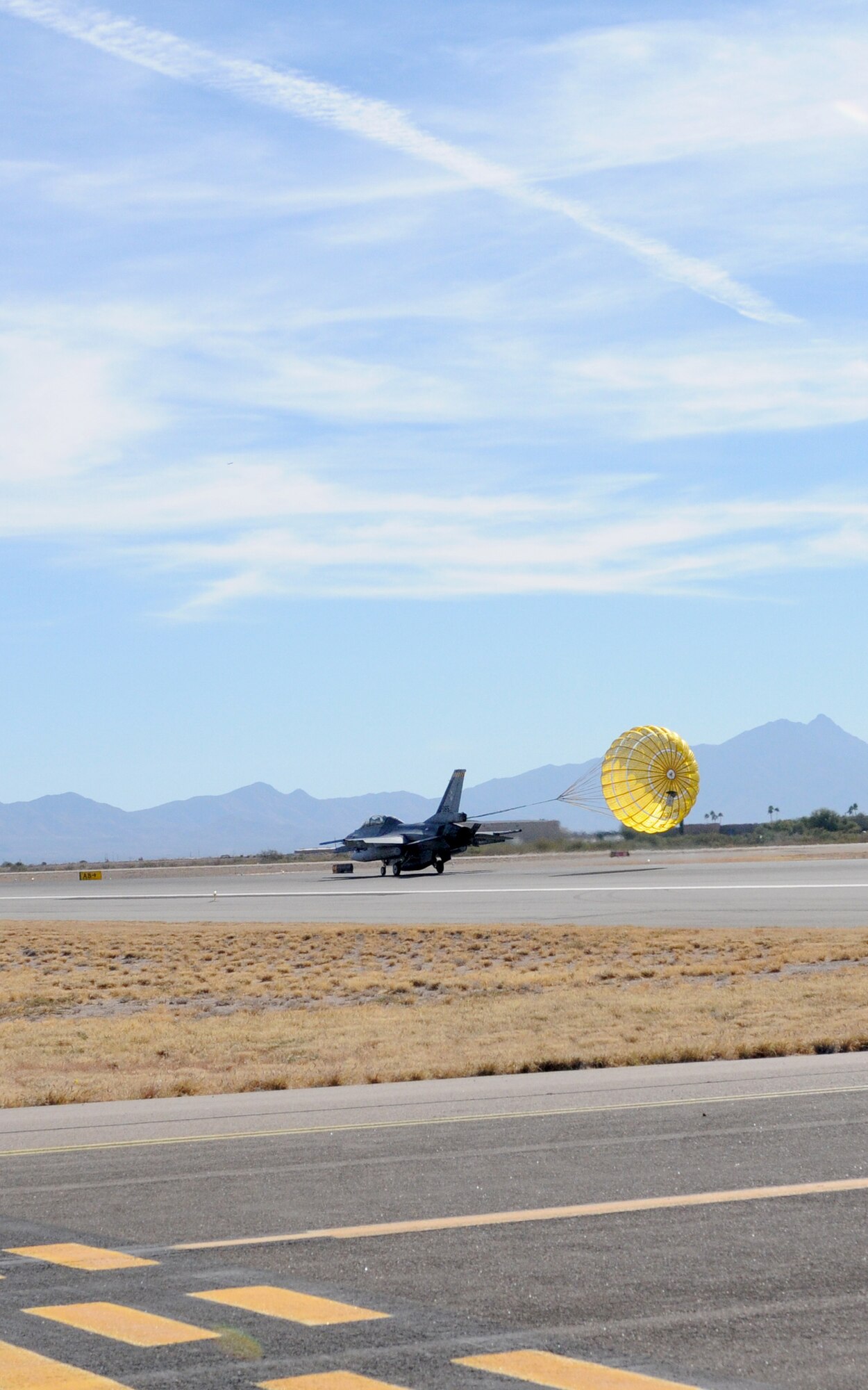 A Royal Netherland’s Air Force F-16 assigned to the Arizona Air National Guard’s 162nd Fighter Wing at Tucson International Airport lands here Friday, Dec. 10, using a drag chute. Chutes are typically employed by Dutch fighters as a safety feature for short field landings and adverse weather conditions. They can reduce the needed runway length by nearly 50 percent. U.S.-owned F-16s at the airport don’t use drag chutes, making this type of landing unique to the Dutch pilot training program here. (U.S. Air Force photo/Maj. Gabe Johnson)