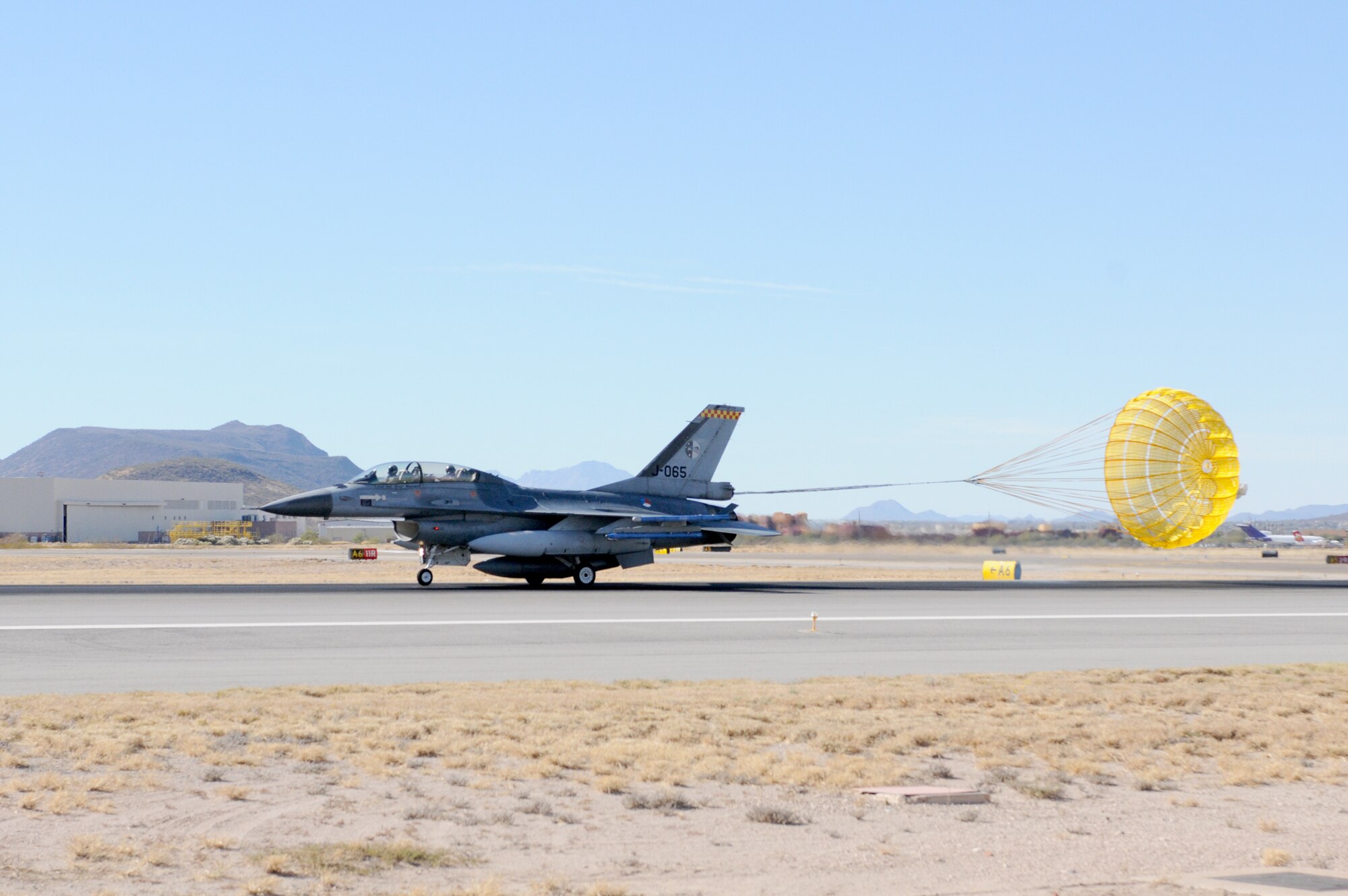 A Royal Netherland’s Air Force F-16 assigned to the Arizona Air National Guard’s 162nd Fighter Wing at Tucson International Airport lands here Friday, Dec. 10, using a drag chute. Chutes are typically employed by Dutch fighters as a safety feature for short field landings and adverse weather conditions. They can reduce the needed runway length by nearly 50 percent. U.S.-owned F-16s at the airport don’t use drag chutes, making this type of landing unique to the Dutch pilot training program here. (U.S. Air Force photo/Maj. Gabe Johnson)
