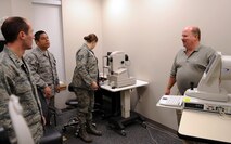 MOODY AIR FORCE BASE, Ga. -- Kevin Ott, representative from manufacturer Carl Zeiss Meditec Inc., answers questions about the new high-definition optical coherence tomography (HD-OCT) machine Dec. 10. The 23rd AMDS will start using the new machine for appointments in the near future. (U.S. Air Force Photo/Airman 1st Class Douglas Ellis)(RELEASED)