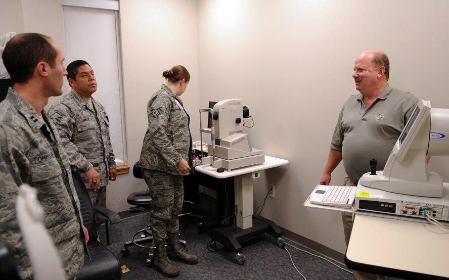 MOODY AIR FORCE BASE, Ga. -- Kevin Ott, representative from manufacturer Carl Zeiss Meditec Inc., answers questions about the new high-definition optical coherence tomography (HD-OCT) machine Dec. 10. The 23rd AMDS will start using the new machine for appointments in the near future. (U.S. Air Force Photo/Airman 1st Class Douglas Ellis)(RELEASED)