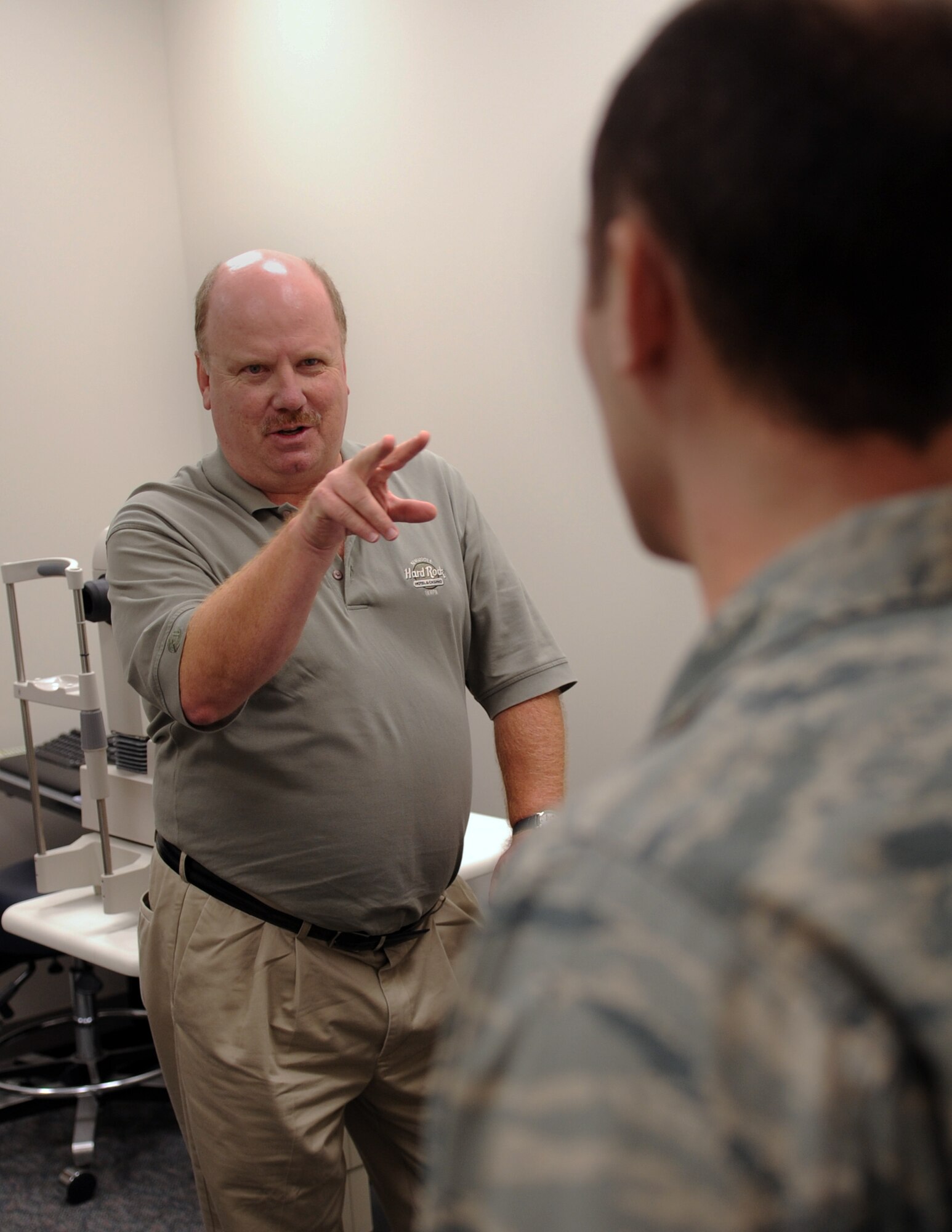 MOODY AIR FORCE BASE, Ga. -- Kevin Ott, representative from manufacturer Carl Zeiss Meditec Inc., describes the new equipment to Capt. Michael Tommolino, 23rd Aerospace Medical Squadron optometry flight commander, Dec. 10. The 23rd AMDS received a high-definition optical coherence tomography (HD-OCT) machine that allows for quicker diagnosis. (U.S. Air Force photo/Airman 1st Class Douglas Ellis)(RELEASED)
